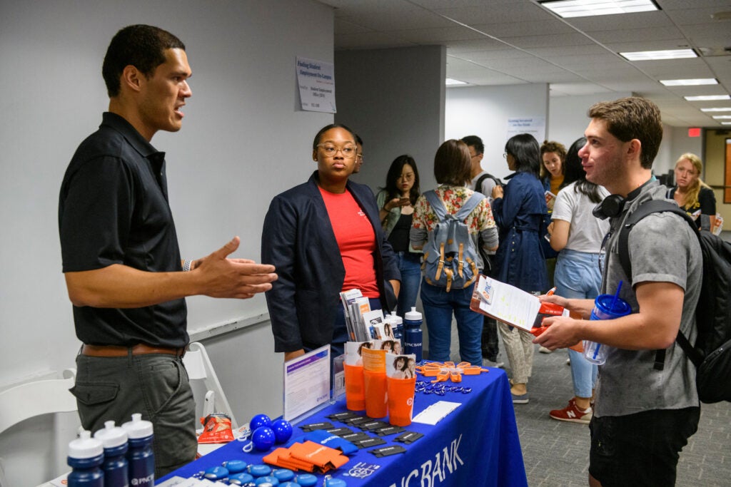 Students at a career fair receiving guidance.