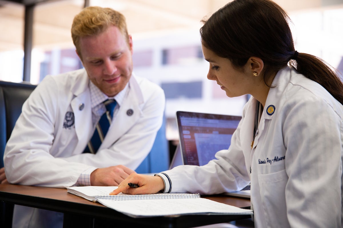 A resident doctor collaborating with her supervisor